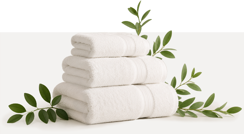 stack of towels with fresh cut leaves surrounding